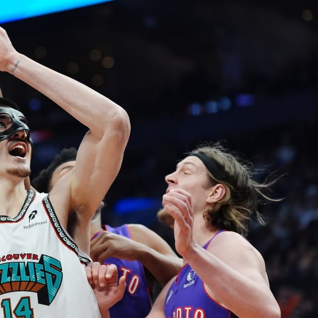 Memphis Grizzlies' Zach Edey (14) protects the ball from Toronto Raptors' Kelly Olynyk (right) during first half NBA basketball action in Toronto on Wednesday, February 5, 2025. THE CANADIAN PRESS/Frank Gunn