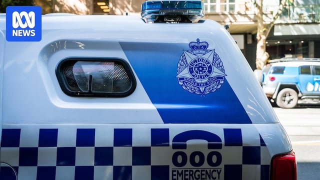 A close up of the back half of a police van which has the police badge and triple zero icons on the side of the vehicle