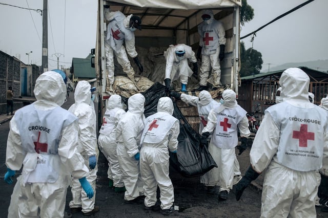 Members of the Congolese Red Cross and Civil Protection unload the bodies of the victims of the recent clashes in Goma for burial, on February 3, 2025.