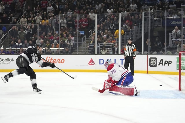 Los Angeles Kings left wing Warren Foegele, left, scores on Montreal Canadiens goaltender Jakub Dobes during a penalty shot in the second period of an NHL hockey game, Wednesday, Feb. 5, 2025, in Los Angeles. (AP Photo/Mark J. Terrill)