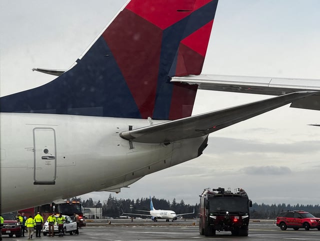 The right wing of a Japan Airlines jet strikes the tail of a Delta Air Lines plane while the aircraft were taxiing at Seattle-Tacoma International Airport in Seattle.