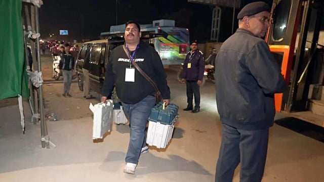 A polling staff carries electronic voting machines (EVM) to a strongroom after voting concluded on Wednesday (ANI)