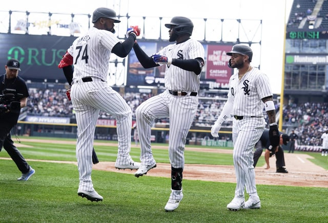 Luis Robert Jr. #88 of the Chicago White Sox is congratulated by Eloy Jimenez #74 of the Chicago White Sox and Yoan Moncada #10 of the Chicago White Sox celebrate.