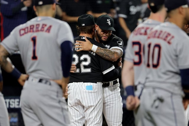 Manager Tony La Russa #22 greets Yoan Moncada #10 of the Chicago White Sox on the field prior to game 3 of the American League Division Series against the Houston Astros at Guaranteed Rate Field on October 10, 2021 in Chicago, Illinois.