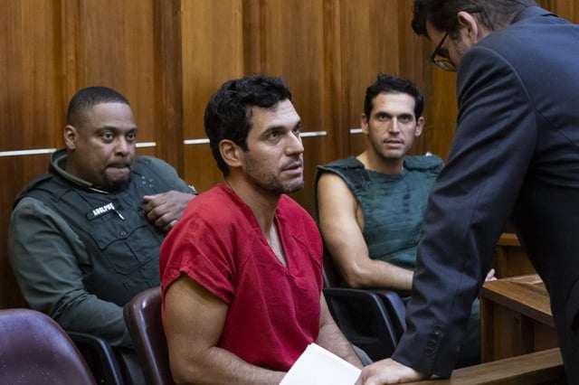 Oren Alexander, 37, center, and his twin brother, Alon, center-right, speak to their attorney Joel Denaro during their bond hearing at the Richard E. Gerstein Justice Building on Friday, Dec. 13, 2024, in Miami.