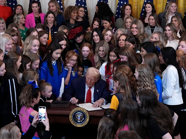 WASHINGTON, DC - FEBRUARY 05: U.S. President Donald Trump joined by women athletes signs the “No Men in Women’s Sports” executive order in the East Room at the White House on February 5, 2025 in Washington, DC. The executive order, which Trump signed on National Girls and Women in Sports Day, prohibits transgender women from competing in women’s sports and is the third order he has signed that targets transgender people. (Photo by Andrew Harnik/Getty Images)