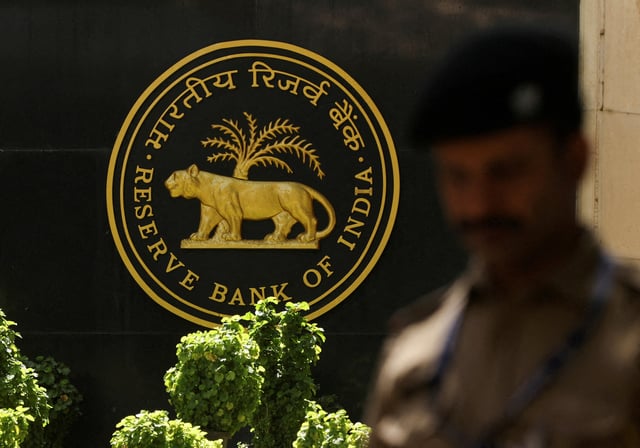 A police officer walks past the Reserve Bank of India (RBI) logo inside its headquarters in Mumbai, India, April 6, 2023. REUTERS/Francis Mascarenhas/File Photo