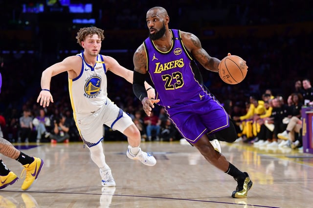 Feb 6, 2025; Los Angeles, California, USA; Los Angeles Lakers forward LeBron James (23) moves to the basket against Golden State Warriors guard Brandin Podziemski (2) during the first half at Crypto.com Arena. Mandatory Credit: Gary A. Vasquez-Imagn Images