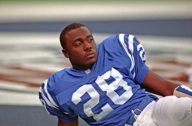 Running back Marshall Faulk #28 of the Indianapolis Colts looks on from the field during pregame warm up before a game against the San Francisco 49ers at the RCA Dome on October 15, 1995 in Indianapolis, Indiana.