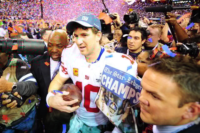 New York Giants quarterback Eli Manning (10) celebrates after Super Bowl XLVI against the New England Patriots at Lucas Oil Stadium.