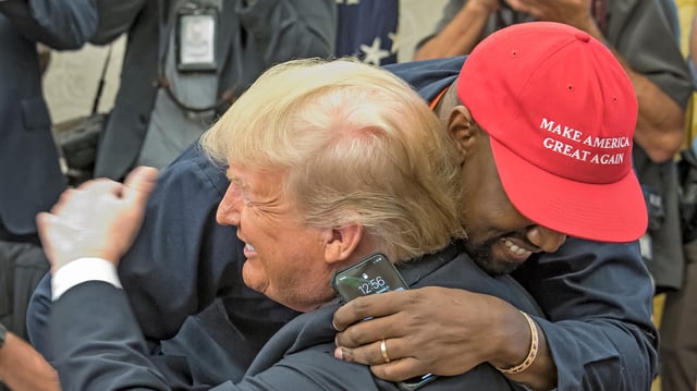 Kanye West embraces real estate developer and US President Donald Trump in the White House&#39;s Oval Office, Washington DC, October 11, 2018.