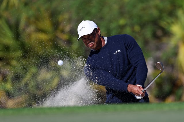 Dec 21, 2024; Orlando, Florida, [USA]; Tiger Woods hits out of the bunker on the fourth hole during the PNC Championship at The Ritz-Carlton Golf Club. Mandatory Credit: Nathan Ray Seebeck-Imagn Images/File Photo