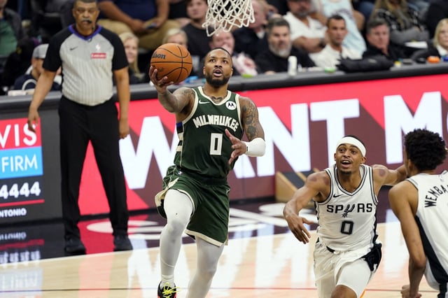 Jan 31, 2025; San Antonio, Texas, USA; Milwaukee Bucks guard Damian Lillard (0) drives to the basket past San Antonio Spurs forward Keldon Johnson (0) during the second half at Frost Bank Center. Mandatory Credit: Scott Wachter-Imagn Images/File Photo