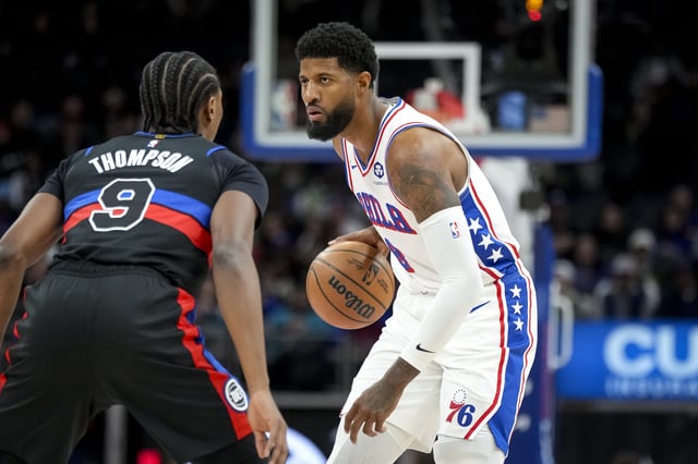 Paul George #8 of the Philadelphia 76ers handles the ball against Ausar Thompson #9 of the Detroit Pistons at Little Caesars Arena on November 30, 2024 in Detroit, Michigan.