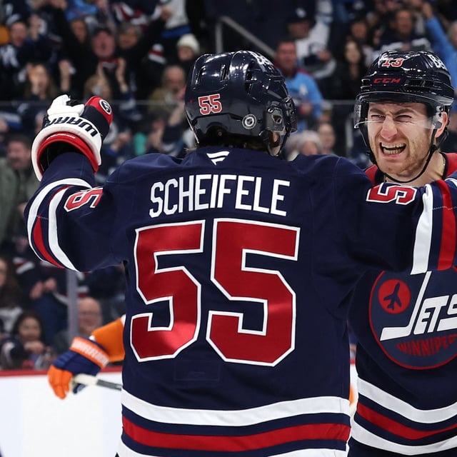 Feb 7, 2025; Winnipeg, Manitoba, CAN; Winnipeg Jets center Gabriel Vilardi (13) celebrates his goal with Winnipeg Jets center Mark Scheifele (55) in the second period against the New York Islanders at Canada Life Centre. Mandatory Credit: James Carey Lauder-Imagn Images