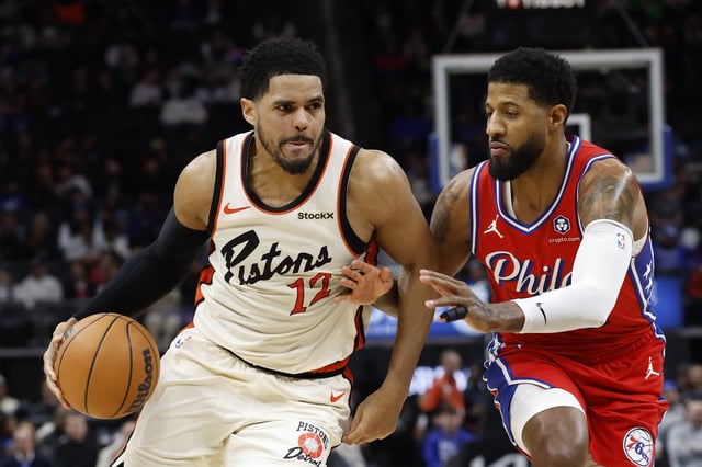 Feb 7, 2025; Detroit, Michigan, USA;  Detroit Pistons forward Tobias Harris (12) dribbles defended by Philadelphia 76ers forward Paul George (8) in the second half at Little Caesars Arena. Mandatory Credit: Rick Osentoski-Imagn Images