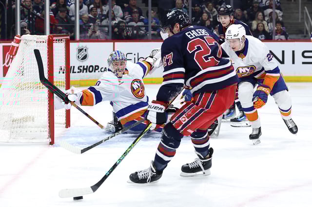 Feb 7, 2025; Winnipeg, Manitoba, CAN; Winnipeg Jets left wing Nikolaj Ehlers (27) readies a shot on New York Islanders goaltender Ilya Sorokin (30) in the second period at Canada Life Centre. Mandatory Credit: James Carey Lauder-Imagn Images
