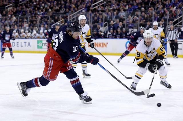 Feb 7, 2025; New York, New York, USA; New York Rangers left wing Artemi Panarin (10) takes a shot against Pittsburgh Penguins defenseman Kris Letang (58) during the second period at Madison Square Garden. Mandatory Credit: Brad Penner-Imagn Images