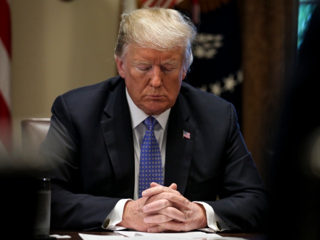 WASHINGTON, DC - AUGUST 01: (AFP OUT) U.S. President Donald Trump prays during a meeting with inner city pastors in the Cabinet Room of the White House on August 1, 2018 in Washington, DC. (Photo by Oliver Contreras - Pool/Getty Images)