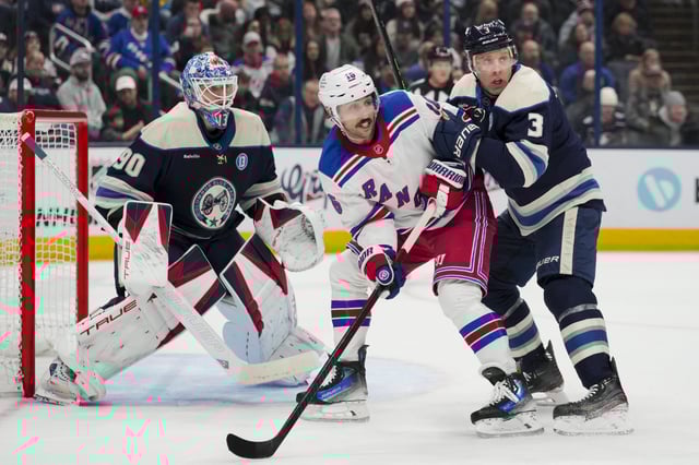 Feb 8, 2025; Columbus, Ohio, USA; Columbus Blue Jackets goaltender Elvis Merzlikins (90) defends the net as New York Rangers center Vincent Trocheck (16) skates against Columbus Blue Jackets defenseman Jack Johnson (3) in the first period at Nationwide Arena. Mandatory Credit: Aaron Doster-Imagn Images