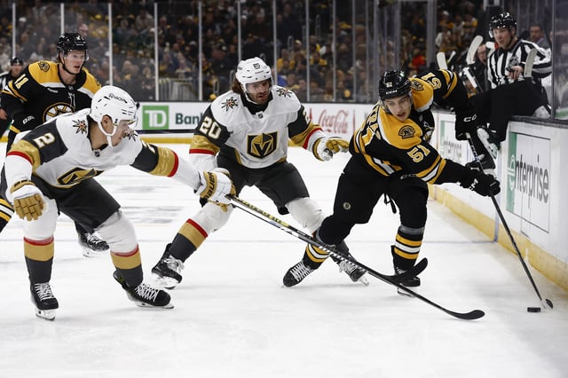 Feb 8, 2025; Boston, Massachusetts, USA; Vegas Golden Knights defenseman Zach Whitecloud (2) and left wing Brandon Saad (20) close in on Boston Bruins center Matt Poitras (51) during the third period at TD Garden. Mandatory Credit: Winslow Townson-Imagn Images