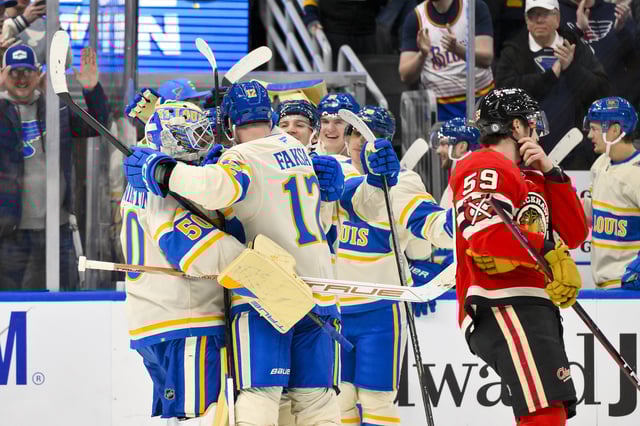 Feb 8, 2025; St. Louis, Missouri, USA;  St. Louis Blues goaltender Jordan Binnington (50) and center Radek Faksa (12) celebrate with teammates after the Blues defeated the Chicago Blackhawks in shootouts at Enterprise Center. Mandatory Credit: Jeff Curry-Imagn Images