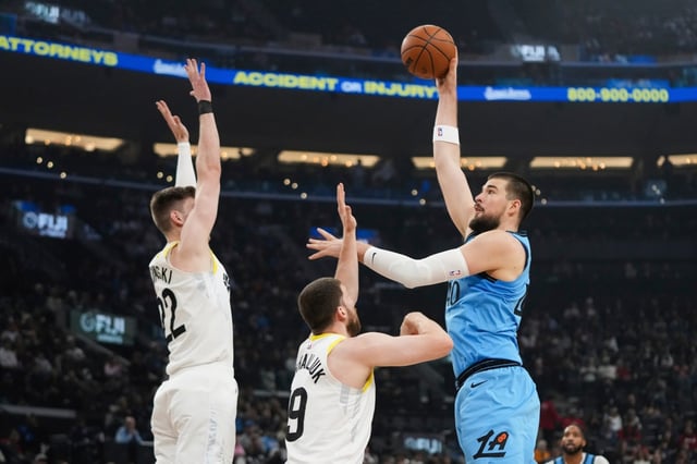 Clippers’ Ivica Zubac, right, looks to shoot under defense by Utah Jazz’s Kyle Filipowski, left, and Svi Mykhailiuk, center, during the first half of an NBA basketball game Saturday, Feb. 8, 2025, in Inglewood, Calif. (AP Photo/Jae C. Hong)
