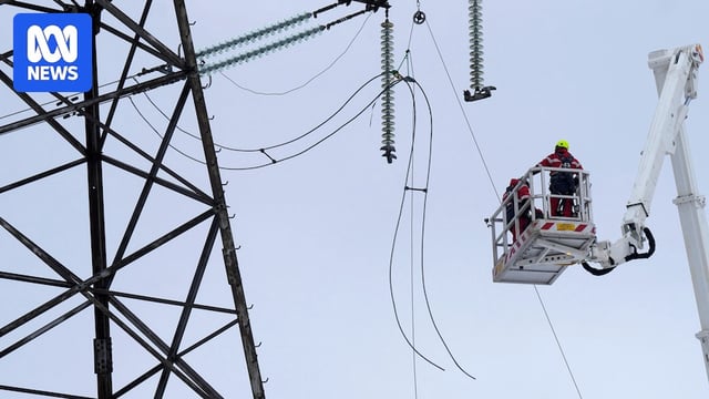two electricians on top of a crane cut power cables in latvia