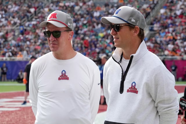 AFC coach Peyton Manning and brother and NFC coach Eli Manning watch during the 2025 Pro Bowl Games.