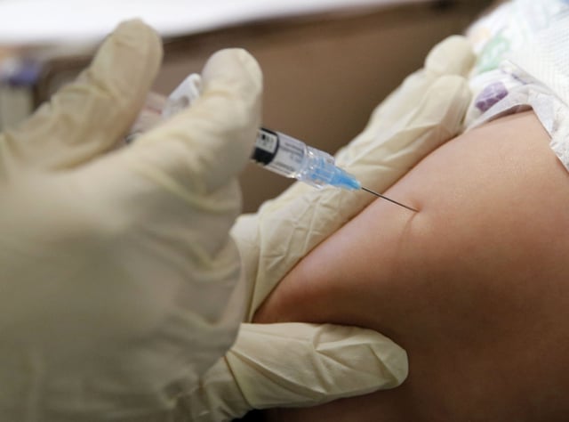 File photo of a child getting a vaccine at the Dallas County Health &amp; Human Services immunization clinic in Dallas on Friday, March 8, 2019.