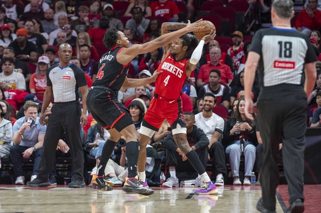 Houston Rockets guard Jalen Green (4) is guarded by Toronto Raptors forward Scottie Barnes (4) in the first half of an NBA basketball game Sunday, Feb. 9, 2025 at the Toyota Center in Houston.