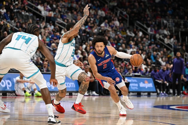Feb 9, 2025; Detroit, Michigan, USA; Detroit Pistons guard Cade Cunningham (2) drives past Charlotte Hornets guard DaQuan Jeffries (3) in the first quarter at Little Caesars Arena. Mandatory Credit: Lon Horwedel-Imagn Images