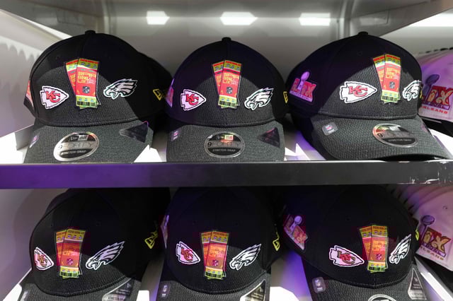 New Era Super Bowl 59 hats with the Philadelphia Eagles and the Kansas City Chiefs logos can be seen on shelves at the NFL Shop at the Super Bowl LIX Experience in New Orleans.