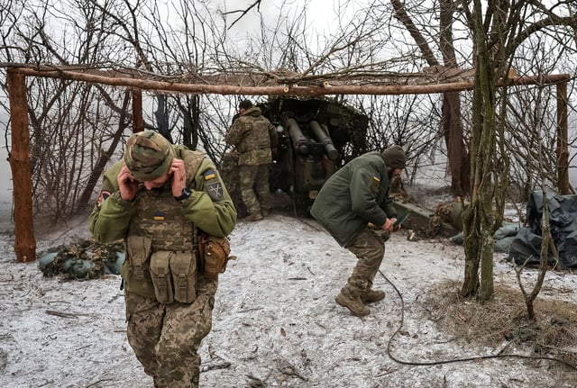 Ukrainian troops fire a howitzer toward Russian positions near Pokrovsk, Donetsk region, Ukraine, February 6, 2025.