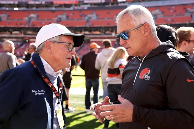 Ohio Gov. Mike DeWine talks with former Ohio State coach Jim Tressel while standing on the sideline prior to the start of an NFL football game between the Cincinnati Bengals and the Cleveland Browns, Sunday, Oct. 20, 2024, in Cleveland. 