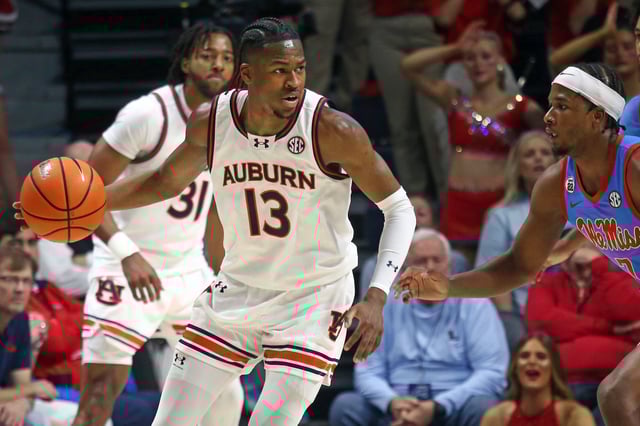 Feb 1, 2025; Oxford, Mississippi, USA; Auburn Tigers guard Miles Kelly (13) dribbles as Mississippi Rebels guard Davon Barnes (7) defends during the second half at The Sandy and John Black Pavilion at Ole Miss. Mandatory Credit: Petre Thomas-Imagn Images/File Photo