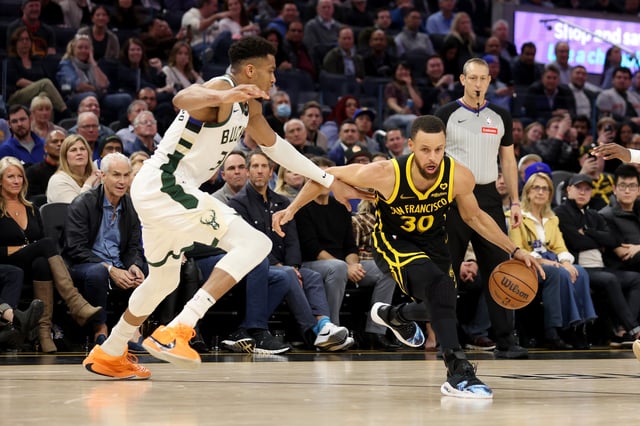 Stephen Curry #30 of the Golden State Warriors is guarded by Giannis Antetokounmpo #34 of the Milwaukee Bucks during the second half of their game at Chase Center on March 06, 2024 in San Francisco, California.