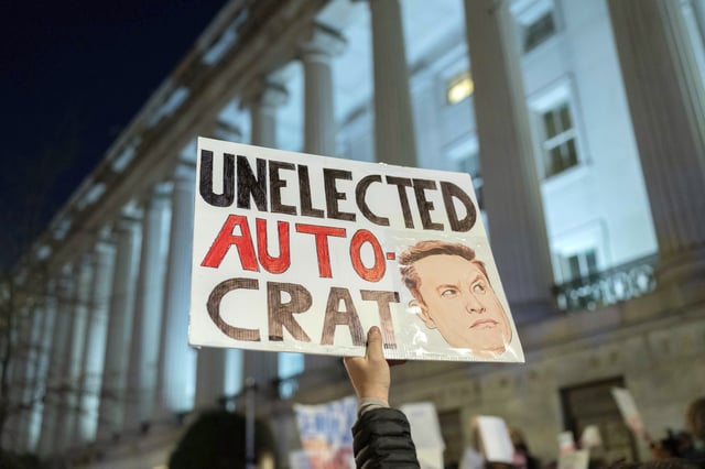 FILE - People protest during a rally against Elon Musk outside the Treasury Department in Washington, Tuesday, Feb. 4, 2025. (AP Photo/Jose Luis Magana, File)