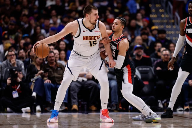 Feb 10, 2025; Denver, Colorado, USA; Denver Nuggets center Nikola Jokic (15) controls the ball as Portland Trail Blazers forward Toumani Camara (33) guards in the second quarter at Ball Arena. Mandatory Credit: Isaiah J. Downing-Imagn Images