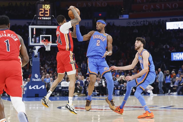 Feb 10, 2025; Oklahoma City, Oklahoma, USA; New Orleans Pelicans guard Jordan Hawkins (24) and Oklahoma City Thunder guard Shai Gilgeous-Alexander (2) fight for a loose ball during the second quarter at Paycom Center. Mandatory Credit: Alonzo Adams-Imagn Images