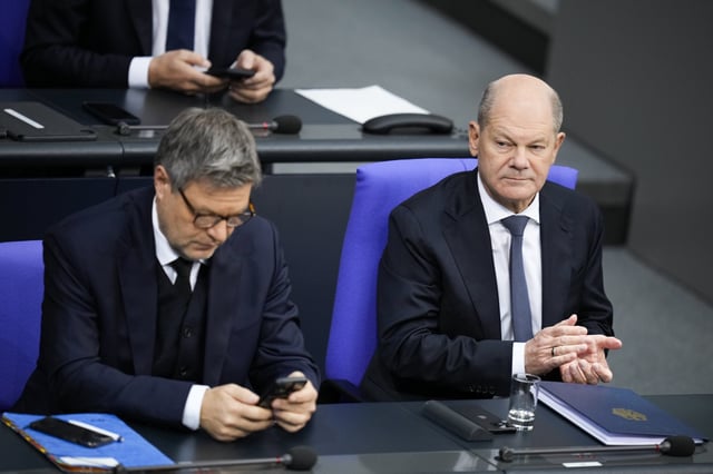 German Chancellor Olaf Scholz, right, and Vice Chancellor and Economy and Climate Minister Robert Habeck, left, attend the last parliament session ahead of national's elections, at the Bundestag parliament in Berlin, Germany, Tuesday, Feb. 11, 2025. (AP Photo/Ebrahim Noroozi)