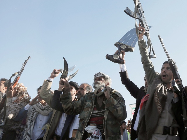 Yemen's Houthi followers brandish weapons and chant slogans as they take part in a protest staged in solidarity with the Palestinian people in Gaza, on January 17, 2025, in Sana'a, Yemen. (Mohammed Hamoud/Getty)