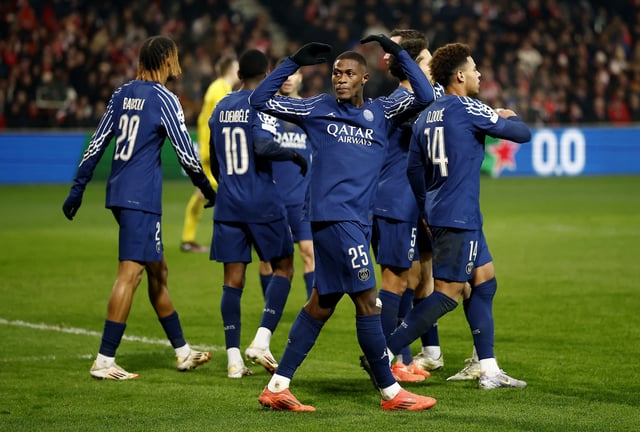 Soccer Football - Champions League - Knockout Phase Playoff - First Leg - Brest v Paris St Germain - Stade de Roudourou, Guingamp, France - February 11, 2025 Paris St Germain's Ousmane Dembele celebrates scoring their third goal with Paris St Germain's Nuno Mendes REUTERS/Stephane Mahe