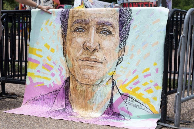 A drawn portrait of Marc Fogel, who has been detained in Russia since August 2021, hangs on rails outside of the White House during a demonstration organized by his family, Saturday, July 15, 2023, in Washington