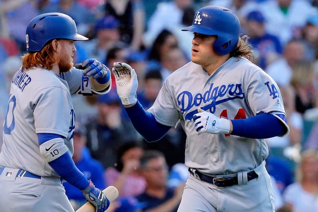 Enrique Hernandez #14 (R) of the Los Angeles Dodgers is congratulated by Justin Turner #10 (L) after hitting a one run home run against the Chicago Cubs during the first inning at Wrigley Field on June 1, 2016 in Chicago.