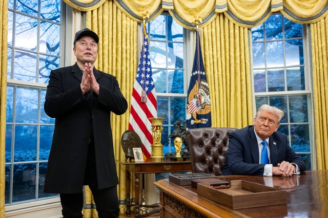 Elon Musk stands near President Donald Trump in the Oval Office of the White House, on Feb. 11, 2025.