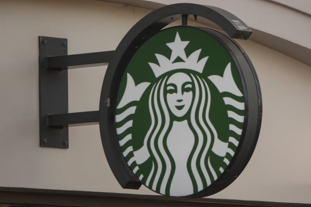 The Starbucks Coffee corporate logo is displayed on a sign at their shop on January 31, 2025 in San Diego, California.