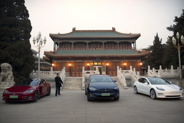 FILE - Tesla vehicles are parked outside of a building at the Zhongnanhai leadership compound during a meeting between Tesla CEO Elon Musk and former Chinese Premier Li Keqiang in Beijing, Wednesday, Jan. 9, 2019. (AP Photo/Mark Schiefelbein, Pool, File)