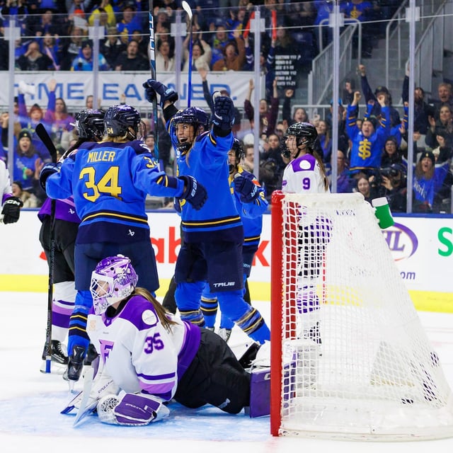 Toronto Sceptres' Natalie Spooner (centre right) celebrates a goal with Hannah Miller (34) as Minnesota Frost goaltender Maddie Rooney (35) lays on the ice during the second period of their PWHL hockey game, in Toronto, Tuesday, Feb. 11, 2025.