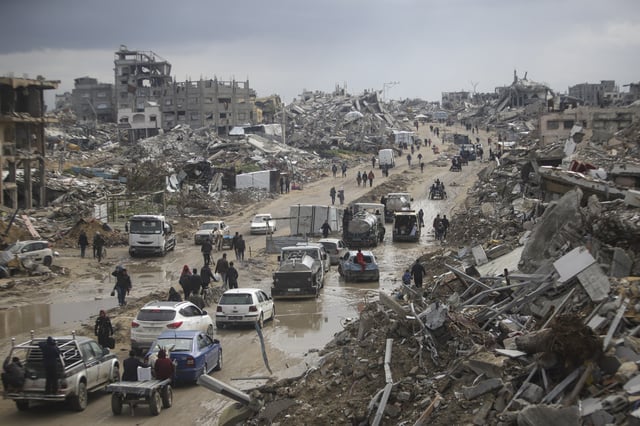 FILE - Cars and pedestrians move along a road amid widespread destruction caused by the Israeli military's ground and air offensive against Hamas in Gaza City's Jabaliya refugee camp, Friday, Feb. 7, 2025. (AP Photo/Jehad Alshrafi, file)